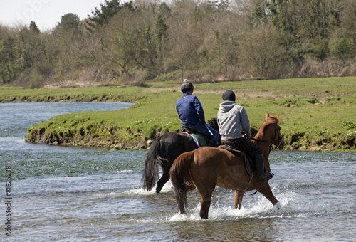 Horse riders on the Ogmore River in South Wales UK