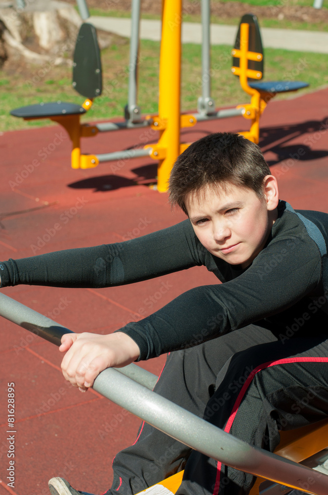 Fototapeta premium The boy on outdoor sport ground / gym