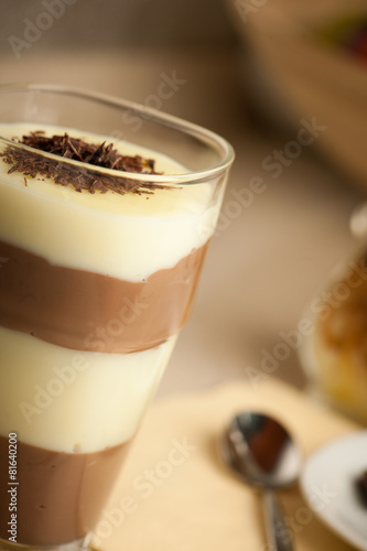 Mixed chocolate and vanilla pudding served in a glass decorated