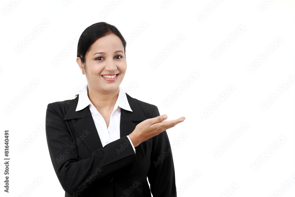 Happy young business woman pointing at copy space Happy young business woman pointing at copy space