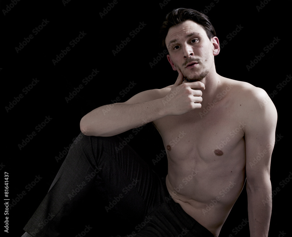 Bare-chested man portrait sitting and looking Bare-chested man portrait sitting and looking
