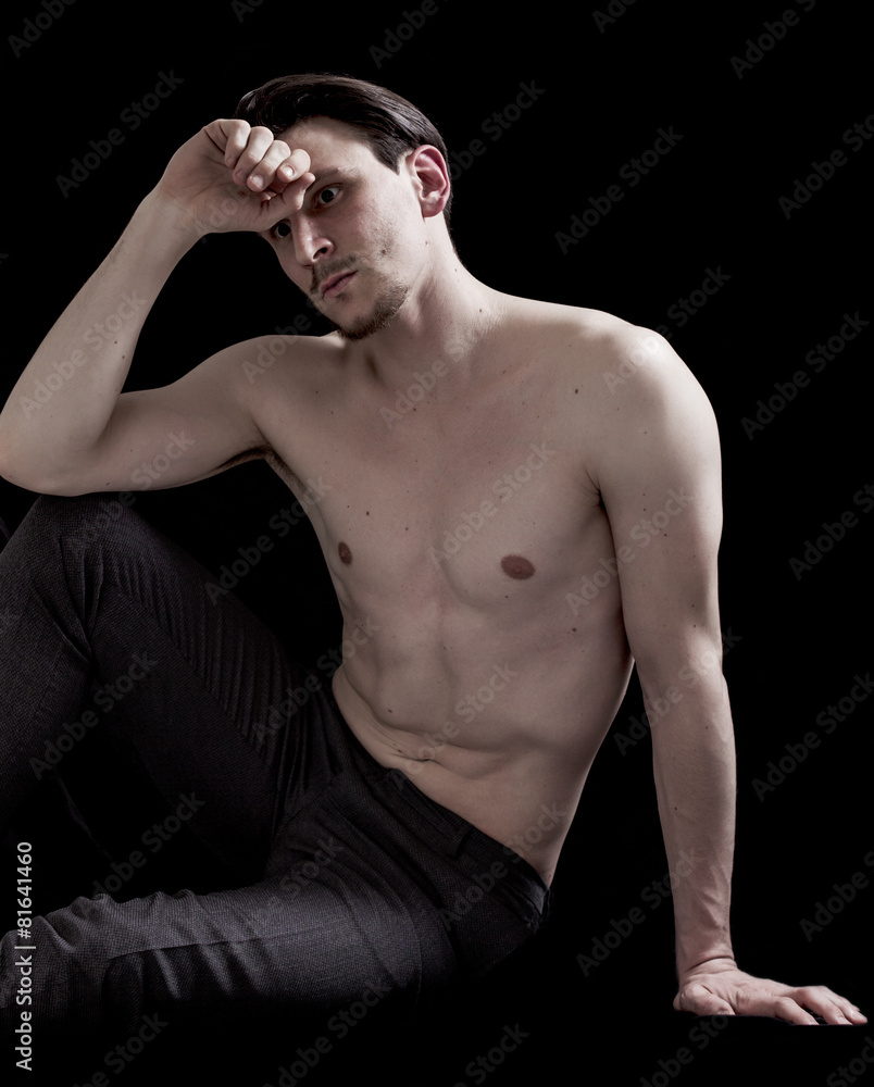 Bare-chested man portrait sitting and thinking