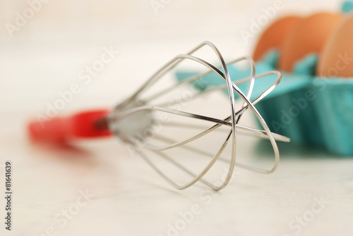 Wire whisk and brown eggs