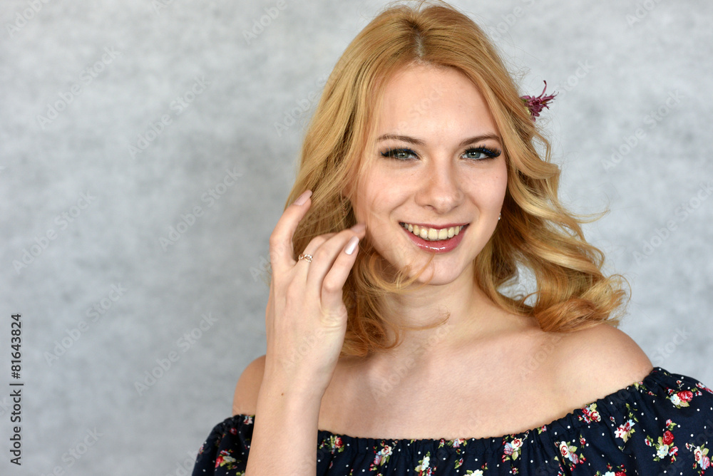 Portrait of young beautiful woman touching her hair Portrait of young beautiful woman touching her hair