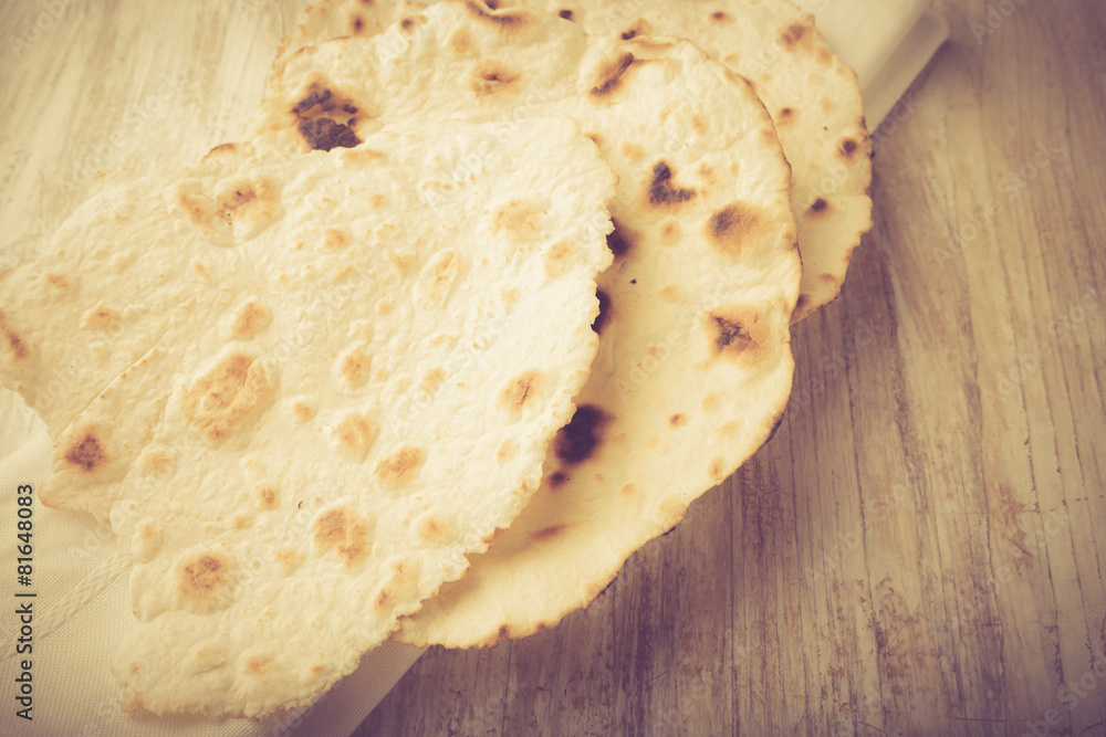 flour tortillas on a wooden table. Unleavened bread. flour tortillas on a wooden table. Unleavened bread.