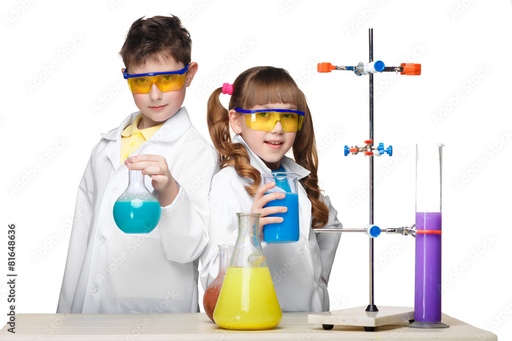 Two cute children at chemistry lesson making experiments Two cute children at chemistry lesson making experiments