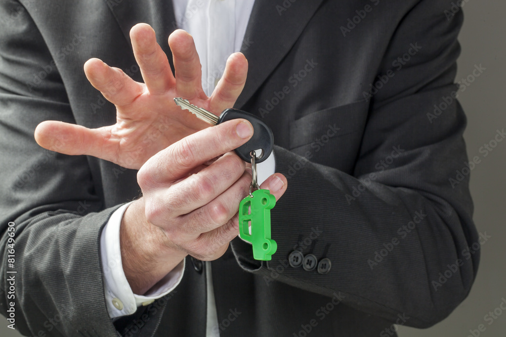 Fototapeta premium male businessman with green car key holder in his hands