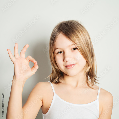 Young girl showing her hand gesture ok