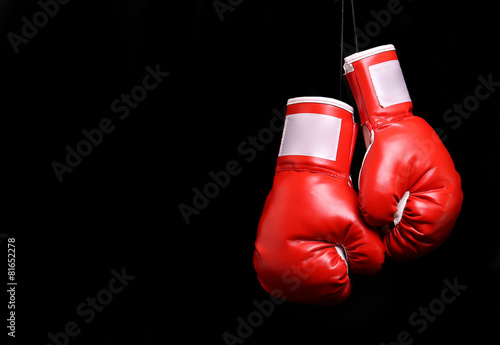 Boxing gloves over black backround © Guzel Studio