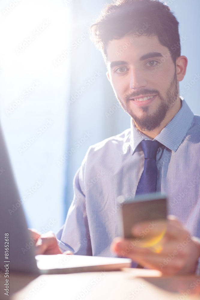 Businessman using laptop at desk Businessman using laptop at desk