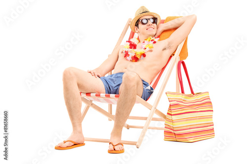 Fotografia, Obraz Relaxed man sitting shirtless in a sun lounger