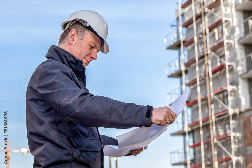 Construction manager with blueprints Construction manager with blueprints