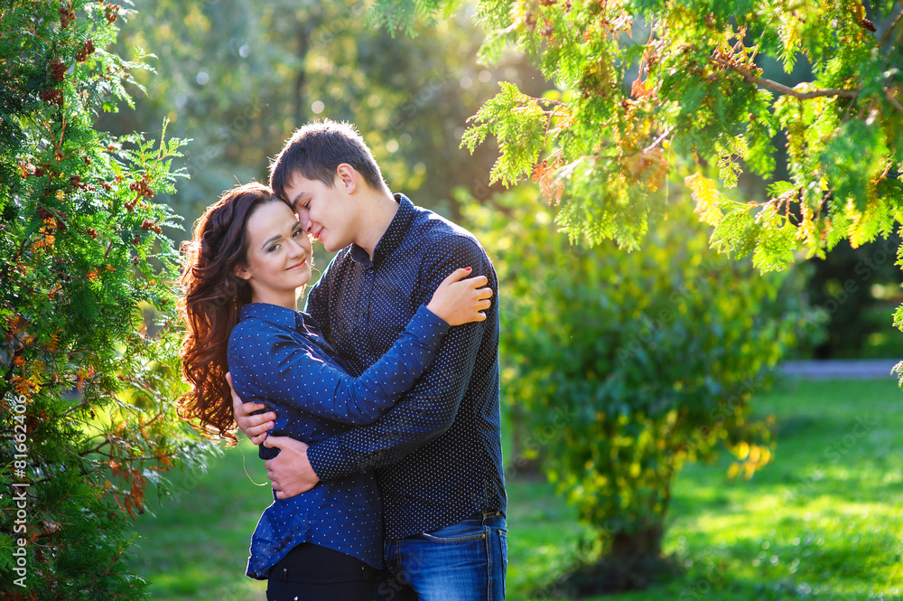 Young couple in love walking in the summer park Young couple in love walking in the summer park