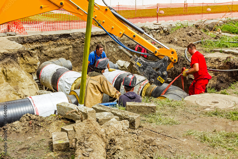 Team of workers on building new pipeline Team of workers on building new pipeline