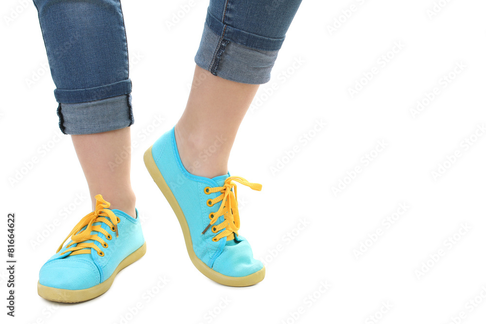 Blue sneakers on girl, young woman legs, isolated