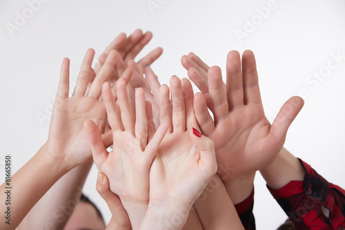 many hands reaching up