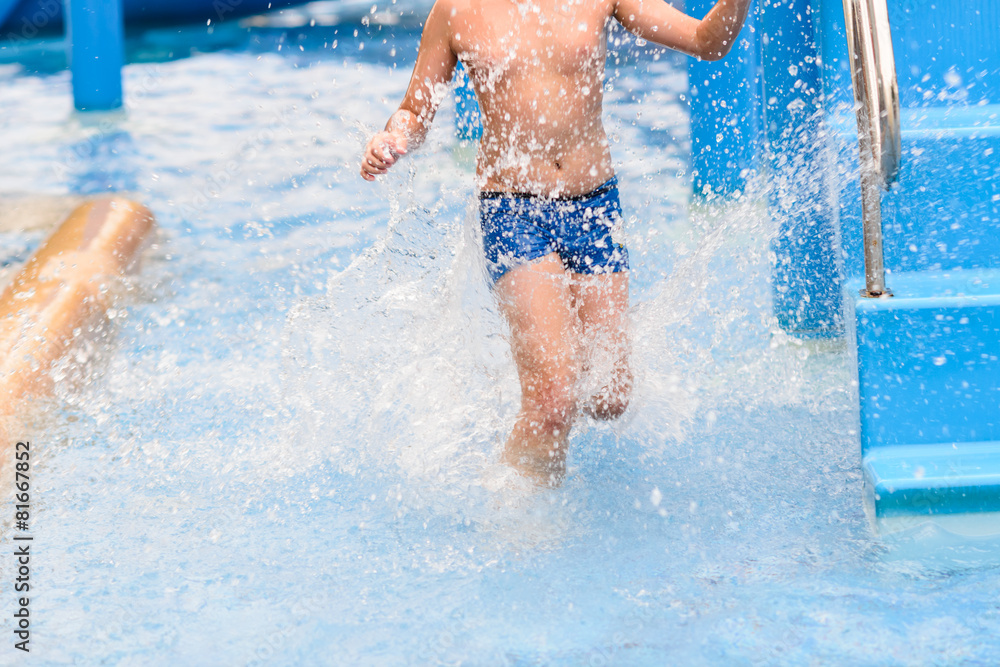 Motion blur boy running in pool.