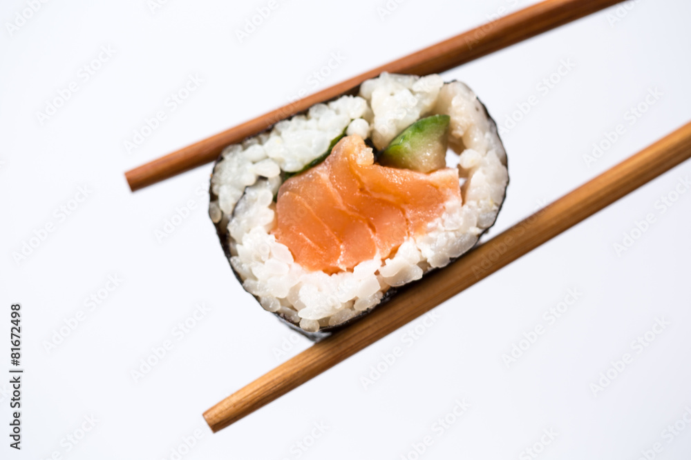 Sushi roll with bamboo chopsticks isolated on white background Sushi roll with bamboo chopsticks isolated on white background