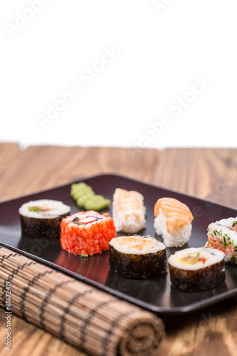 Wallpaper Mural fresh Japanese tasty sushi roll set with chopsticks on table Torontodigital.ca