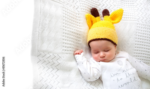Baby sleeping in giraffe hat