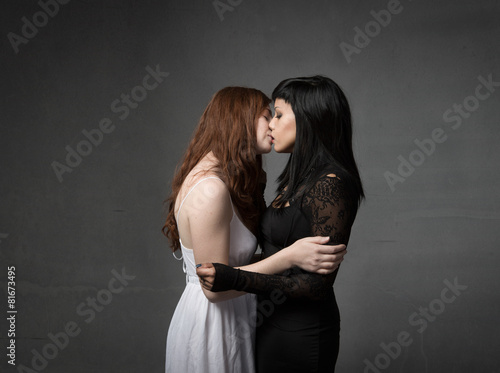 lesbians kisses in dark background photo