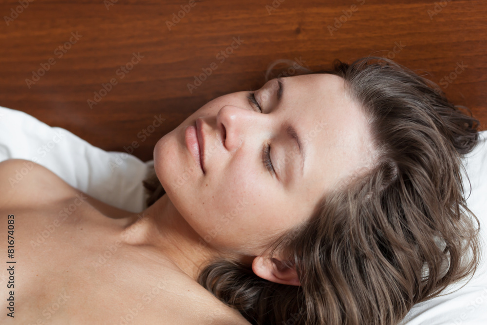 Young naked woman sleeping in white bed in the morning Young naked woman sleeping in white bed in the morning