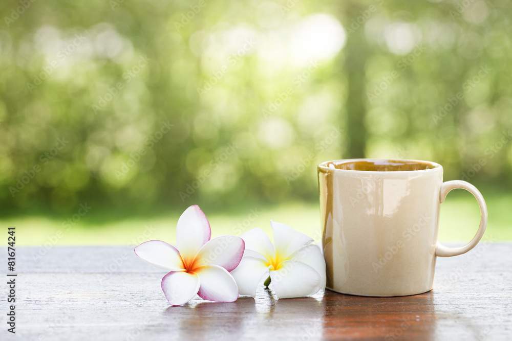 Coffee with flowers on wooden table Coffee with flowers on wooden table