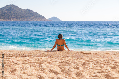 Young woman resting on the beach Kaputash, Turkey