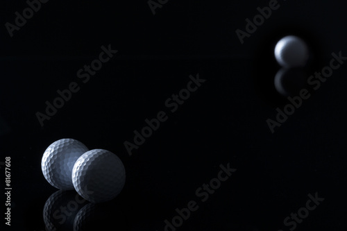 Golf balls isolated on black background.