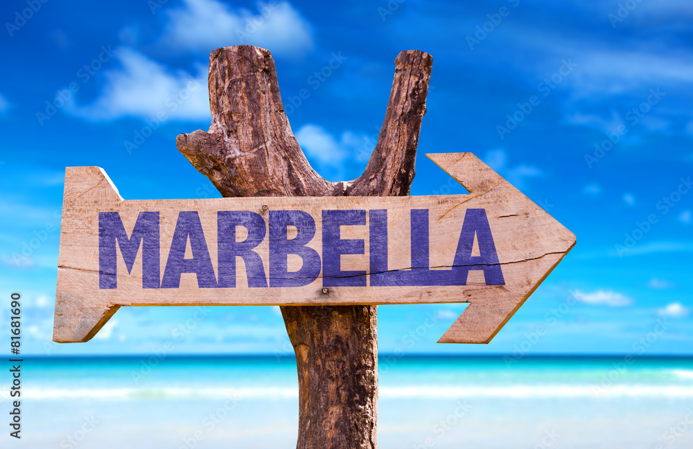 Marbella wooden sign with beach background