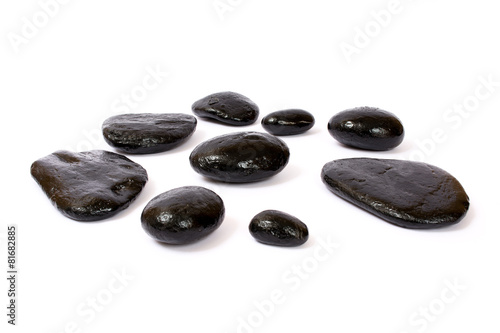 Black wet stones on white background