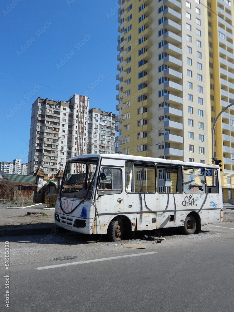 Broken city bus after street riots