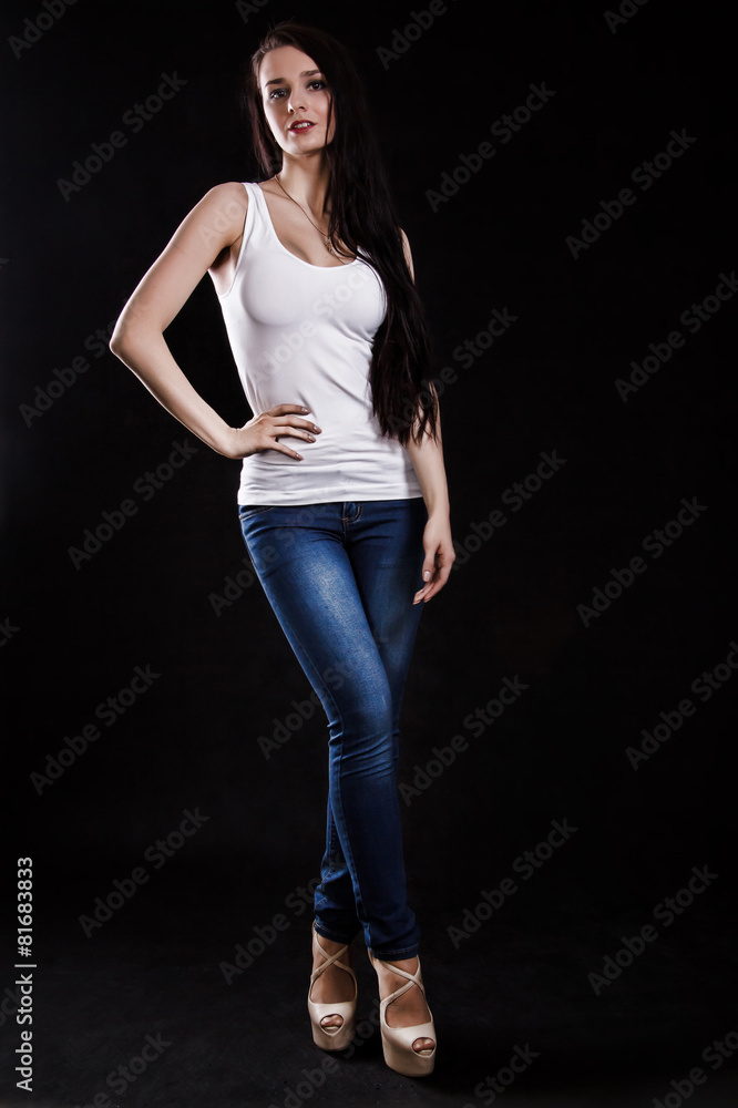 Beautiful young woman in a white shirt and blue jeans Beautiful young woman in a white shirt and blue jeans