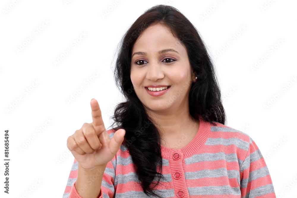 Smiling young woman touching imaginary screen with her finger Smiling young woman touching imaginary screen with her finger