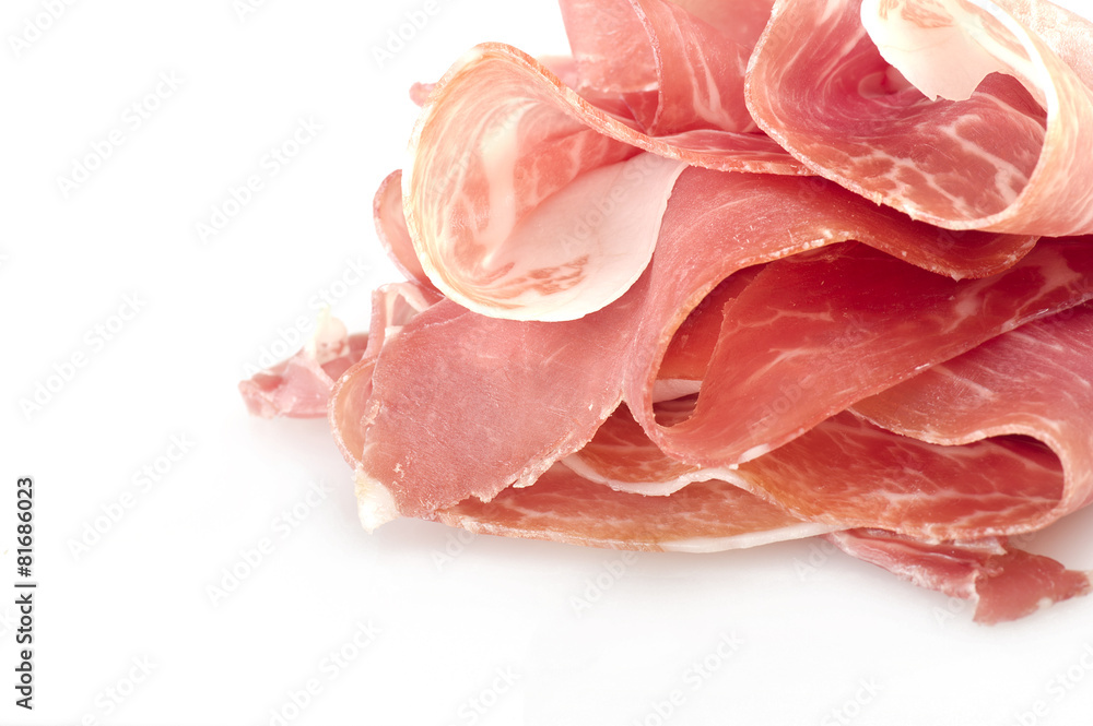 Italian prosciutto crudo ,raw ham leg sliced on white Italian prosciutto crudo ,raw ham leg sliced on white