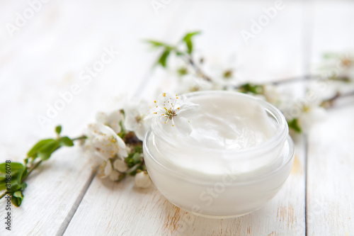 Skin cream and beautiful spring white flower