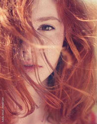 Portrait of red-haired girl close-up