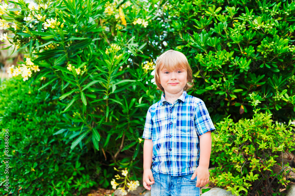 Outdoor portrait of a cute little boy, wearing plaid blue shirt Outdoor portrait of a cute little boy, wearing plaid blue shirt