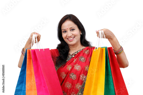 Traditional Indian woman holding shopping bags © godsandkings