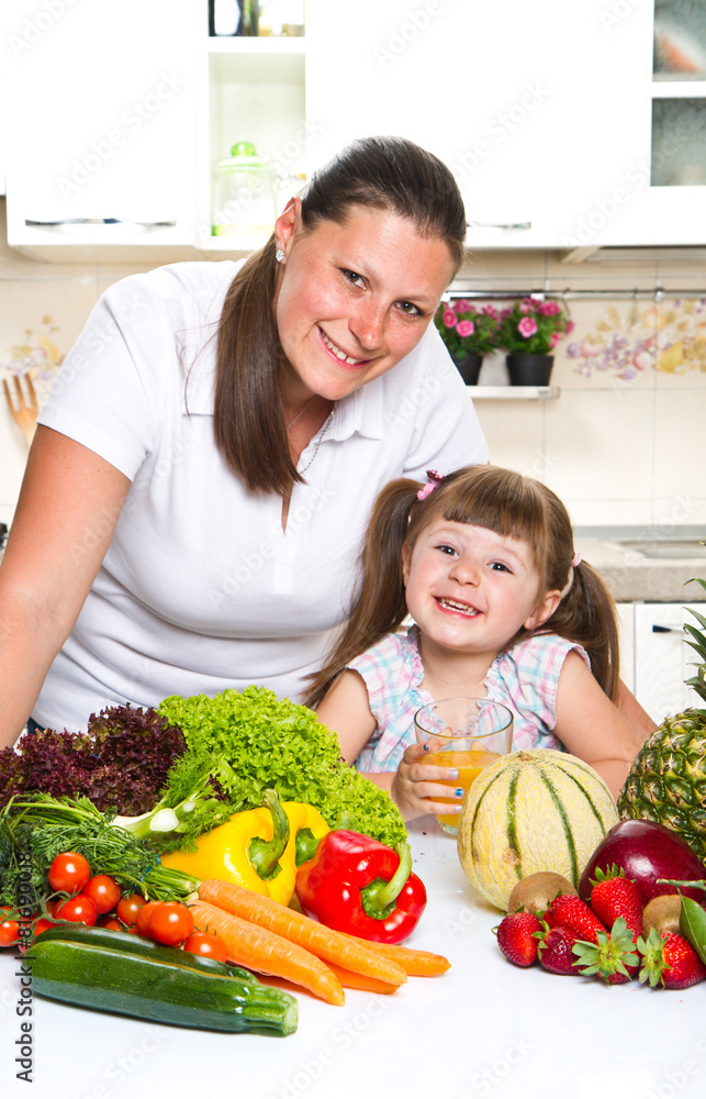 happy mother and daughter smiling in the kitchen happy mother and daughter smiling in the kitchen
