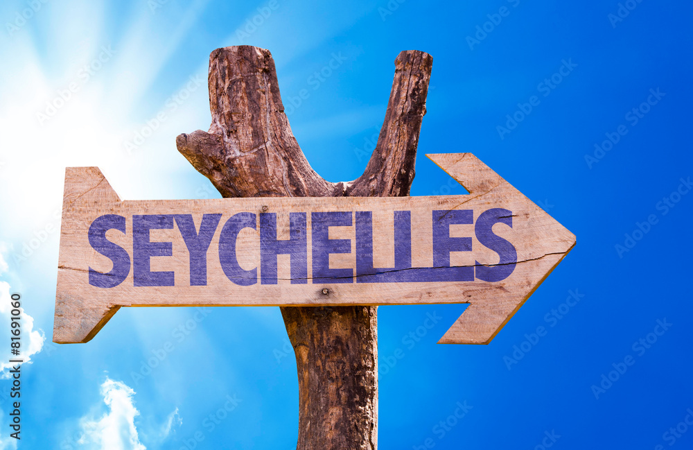 Seychelles wooden sign with sky background