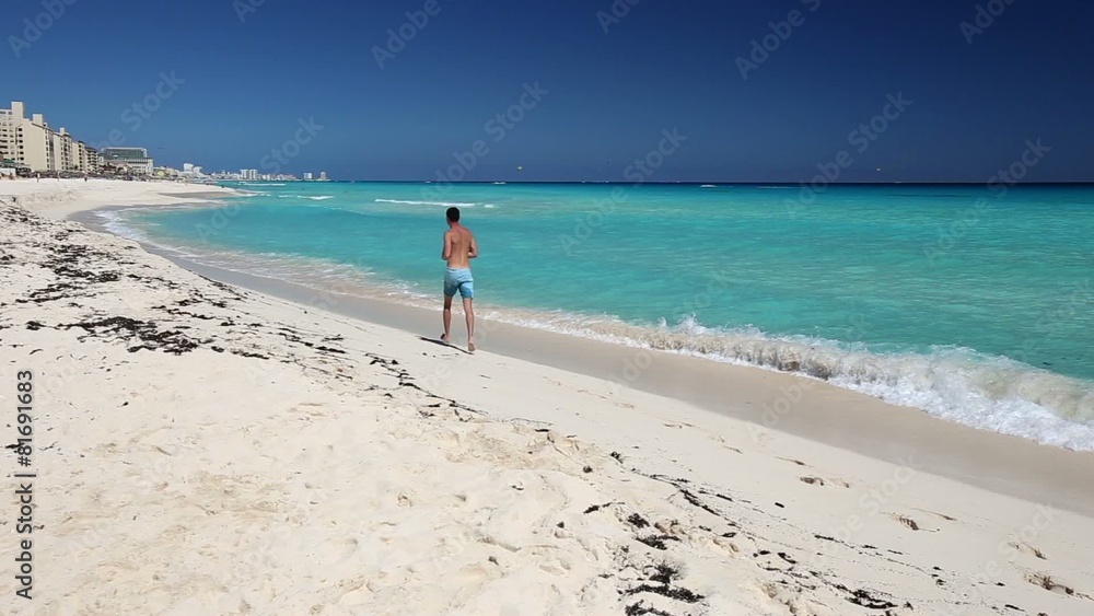 Athletic man jogging on caribbean beach Athletic man jogging on caribbean beach