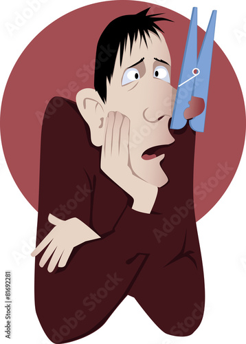 Nasal congestion. Man with a clothespin on his nose