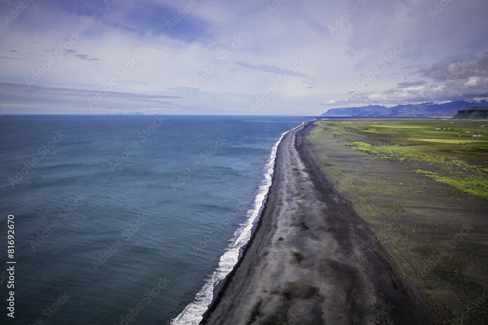The black sand beach with Icelandic coastline