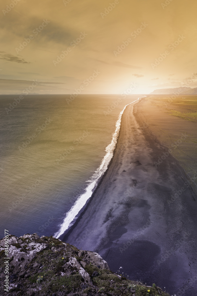 Fototapeta premium The black sand beach with Icelandic coastline