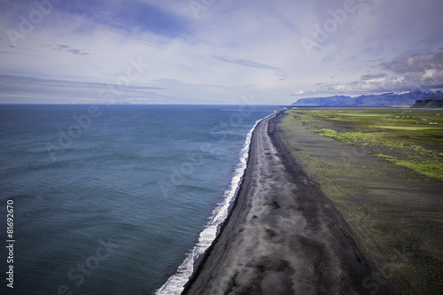 The black sand beach with Icelandic coastline