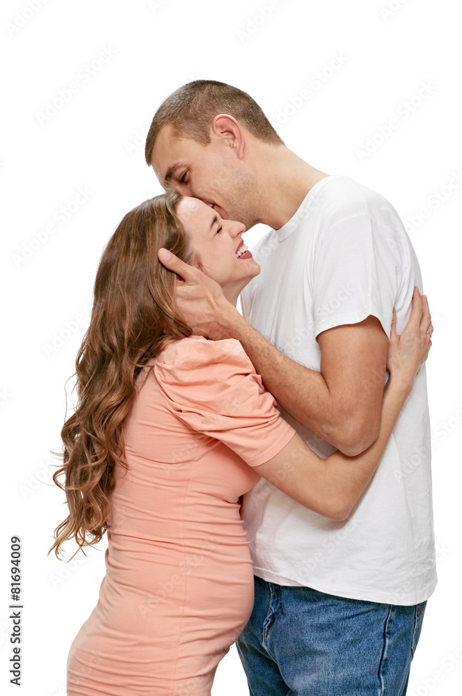 kissing pregnant couple