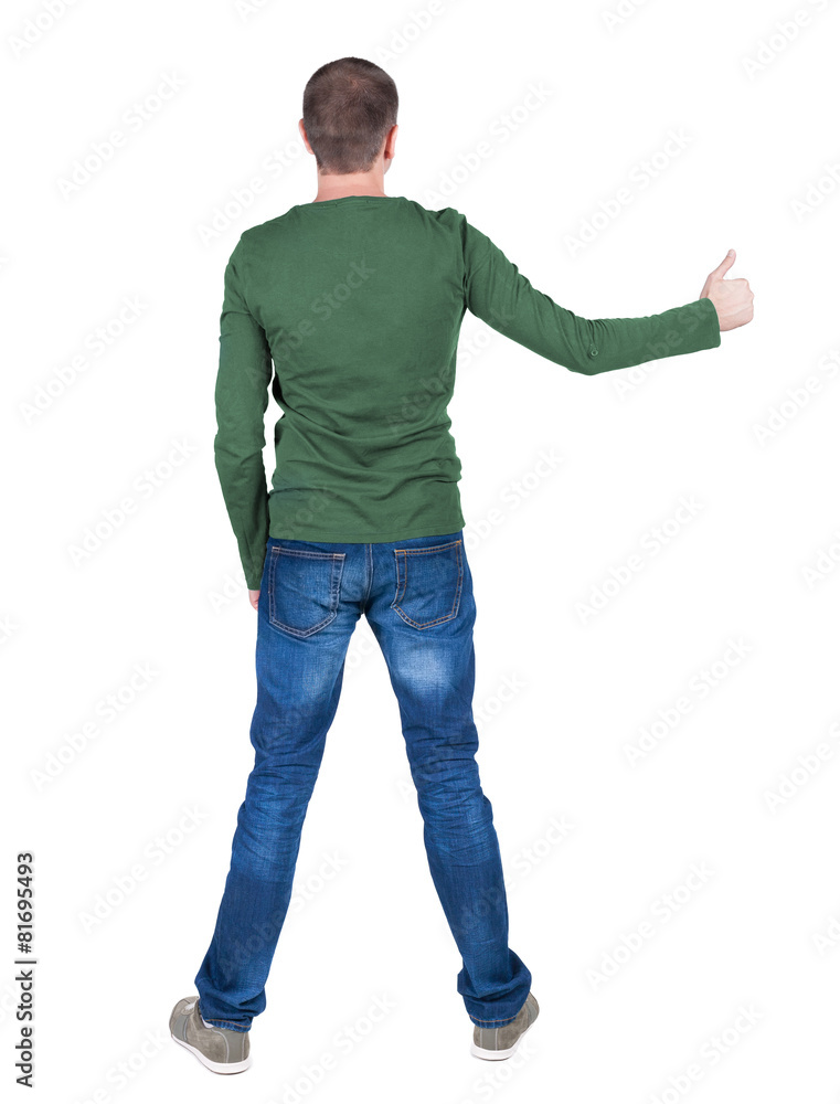 Back view of man in t-shirt. shows thumbs up. Back view of man in t-shirt. shows thumbs up.