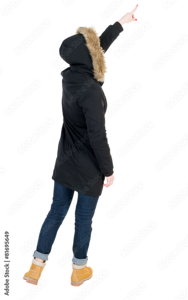 Back view of pointing young women in parka. Back view of pointing young women in parka.