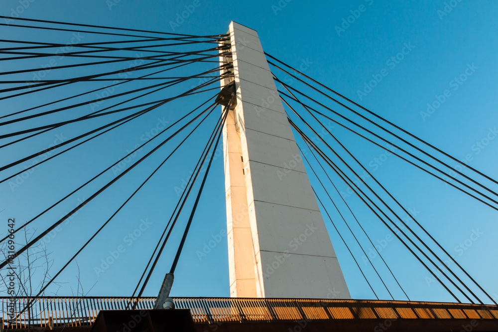 White steel cable bridge in modern architecture style